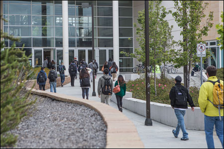 Students walk toward the entrance to City College of San Francisco